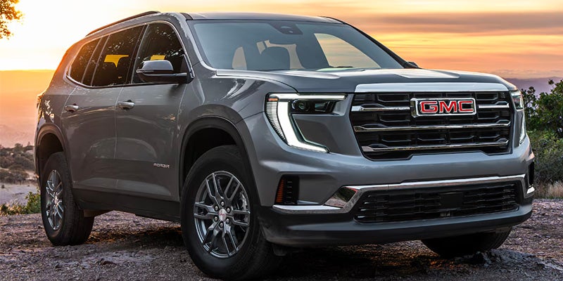 2026 GMC Acadia parked in nature with sunset lighting